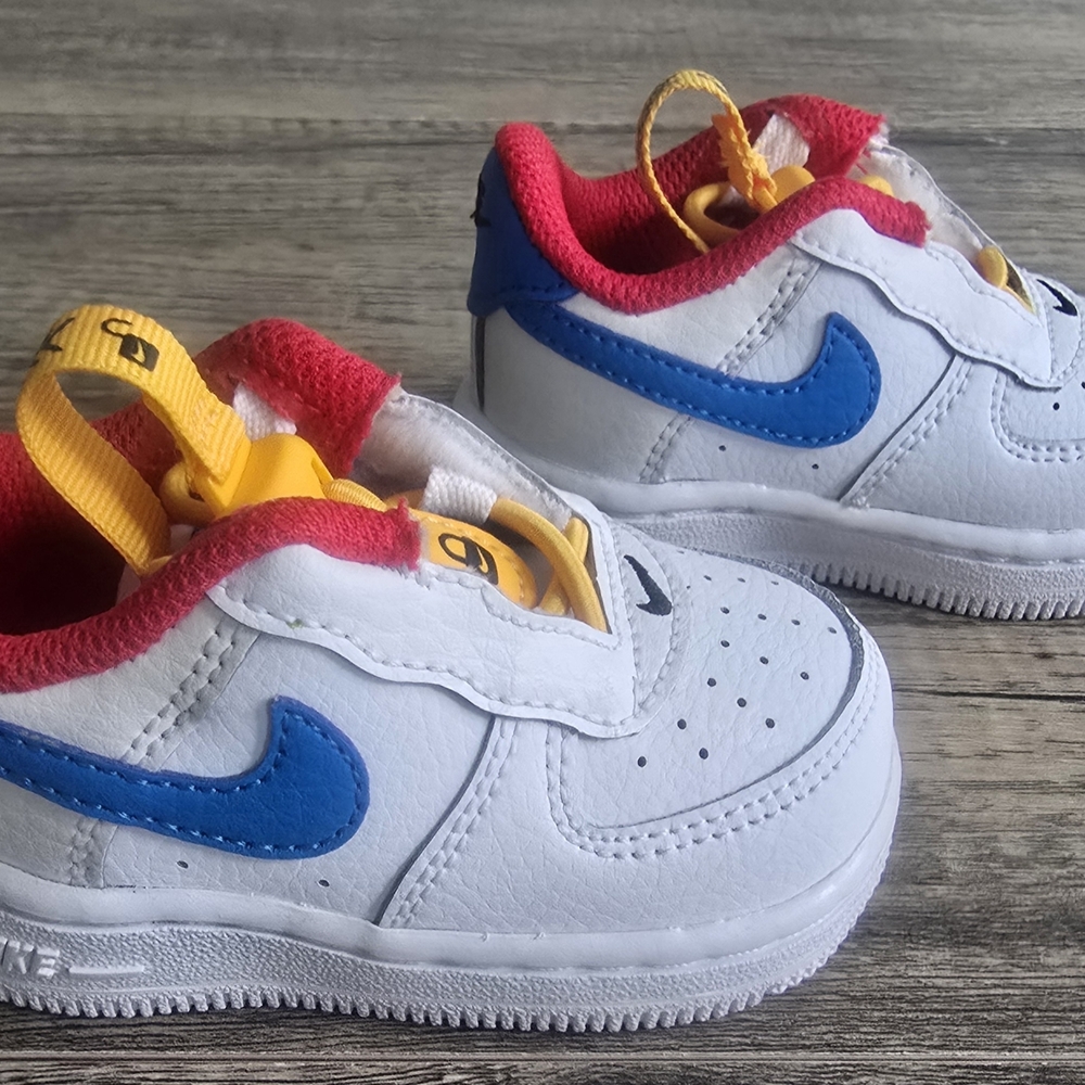 Nike White Baby Sneakers with Blue Swoosh and Red Lining